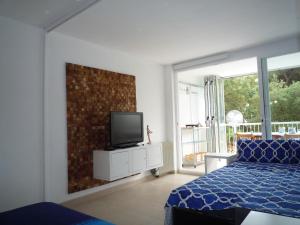 普拉加德阿罗Tramuntana的一间卧室配有一张床,墙上配有电视