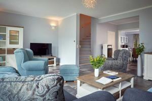 奥斯赛拜-塞林Villa Emma的客厅配有蓝色的椅子和桌子