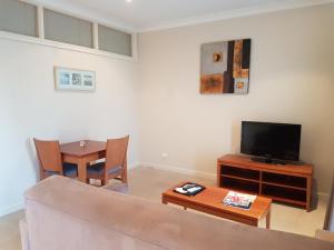努里乌特帕巴罗莎美酒酒店的带沙发、电视和桌子的客厅