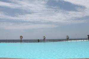 伊基克Iquique Playa Brava 1670的海滩旁的蓝色大泳池