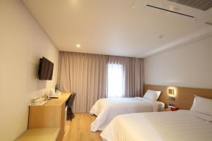 釜山天使酒店的酒店客房设有两张床和电视。