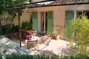 圣保罗-德旺斯Au vallon rouge (Suite double)的一个带桌椅的庭院和一座房子