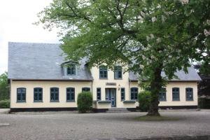 KværsBremsmaj Farm Holiday的前面有一棵树的白色房子