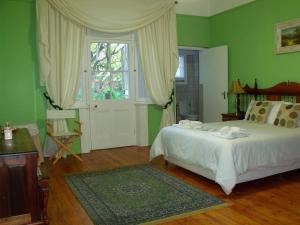 奥茨胡恩比西比旅馆的绿色卧室设有床和窗户