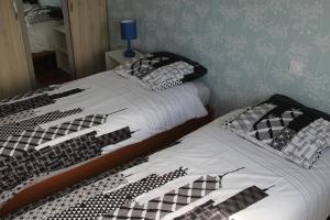 圣马洛Appartement lumineux et Agréable 6 Personnes的两张带黑白床单和枕头的床