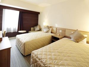 神户三宫优尼佐酒店客房内的一张或多张床位