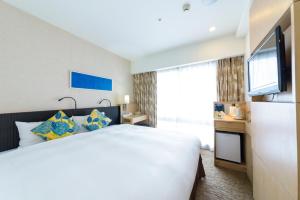 那霸那霸西铁度假酒店的配有一张床和一台平面电视的酒店客房