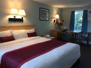 丹尼斯港The Cutty Sark的酒店客房设有床、桌子和窗户。