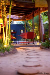 瓦加杜古Villa Kaya Lodge的树屋下的红椅