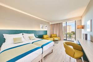 乌马格Hotel Sipar Plava Laguna的酒店客房,配有一张床、一张桌子和椅子
