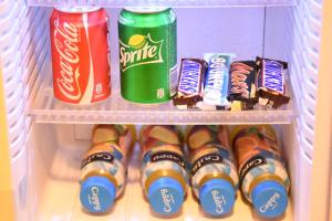 纳布卢斯Orient Hotel的冰箱装满饮料、牙刷和糖果