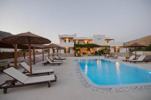 伊奥斯乔拉Villa Maria的毗邻度假酒店的带椅子和遮阳伞的游泳池