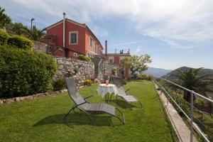 基亚瓦里Rosso su Portofino的房子前面的草上摆放着桌椅