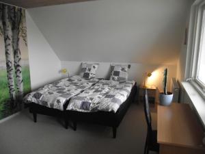 尼克宾法尔斯特Bed and Breakfast Hasseloe的一间带床的卧室,位于带窗户的房间内