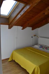 阿科Casa River - CIPAT 022006-AT-059712的一间卧室设有一张黄色的床和窗户
