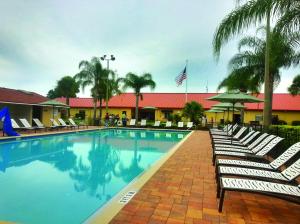 奥兰多Orlando RV Resort的一个带躺椅和美洲旗的大型游泳池