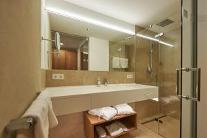 施图本阿尔贝格爱普帕斯特酒店的一间带水槽和玻璃淋浴的浴室