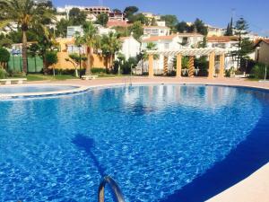 佩尼斯科拉Residencial Estibaliz的一个大型蓝色游泳池,其建筑背景为:
