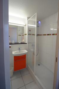 圣萨蒂南The Originals City, Hôtel Alizéa, Le Mans Nord (Inter-Hotel)的白色的浴室设有水槽和淋浴。