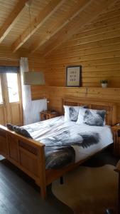 Laag-SoerenDe Priesnitzhoeve的小木屋内一间卧室,配有一张大床