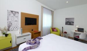 麦纳麦ibis Styles Manama Diplomatic Area的一间酒店客房,配有一张床和一台电视