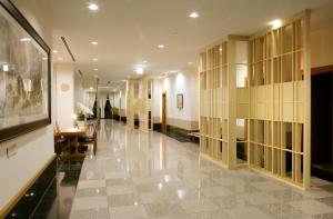 高山Nakao Kogen Hotel Kazaguruma的大楼的走廊,配有桌椅