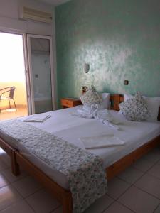 基尼拉Haus Sofis的一间卧室配有一张带白色床单的大床