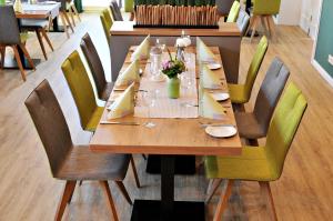 加瑞尔布格克劳斯塔普肯餐厅酒店的一张长木桌子,四周摆放着椅子