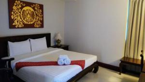 Sawankhalok萨旺卡布里精品酒店的一间卧室配有一张床,上面有两条毛巾