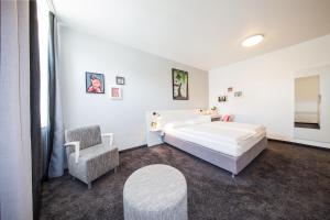 柏林柏林科尔马米特酒店的白色卧室配有床和椅子