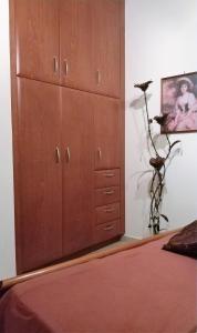 基萨莫斯Rosmarino的卧室内的大型木制橱柜,配有床