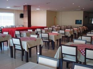 波多韦柳华丽套房酒店的一间带桌椅和红色柜台的用餐室
