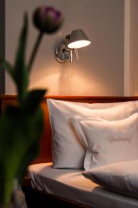 哈默尔恩加尼克里斯蒂伦贺夫历史酒店的一间卧室配有一张带台灯和枕头的床