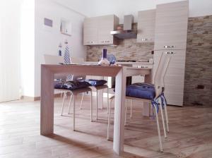 圣安吉罗山Le Casette nel Rione的厨房配有木桌和椅子