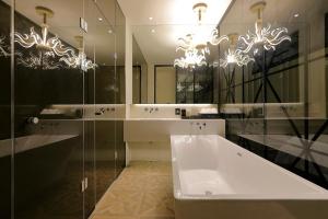 龙仁市伊斯基亚酒店的一间带浴缸和大镜子的浴室