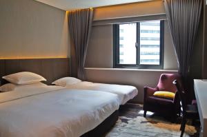 台北兄弟大饭店的酒店客房设有两张床和窗户。