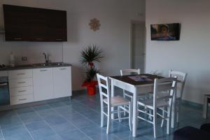 阿杰罗拉Il Balcone delle Dee的厨房配有桌椅和水槽。