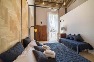 那不勒斯The Dante House by House In Naples的一间带两张床和一张沙发的客厅