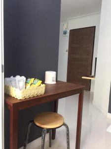 莱卡邦素万那普A普勒斯旅馆的一张桌子、凳子和一张桌子及洗浴用品