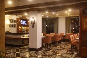 马尼拉Herald Suites Polaris的餐厅设有酒吧和桌椅