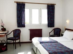 塞威恩罗格斯艾登拉克酒店的一间卧室配有一张床、两把椅子和一个窗户