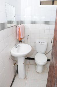 达累斯萨拉姆Safari Inn的白色的浴室设有卫生间和水槽。