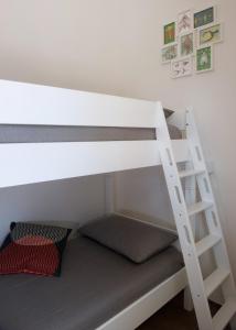 托雷坎内Via Del Faro Apartments的双层床的下铺配有梯子