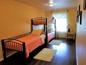 奥克赫斯特迷人楼下公寓的一间卧室设有两张双层床和一扇窗户。
