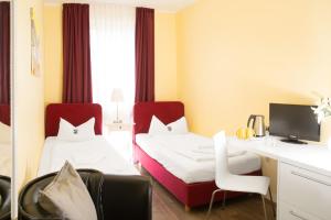 杜塞尔多夫巴塞罗那住宿&早餐酒店的酒店客房配有两张床和一张书桌