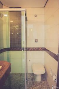 圣贝尔纳多-杜坎普Jardim Hotel的一间带卫生间和玻璃淋浴间的浴室