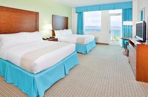 彭萨科拉海滩彭萨科拉海滩度假村的酒店客房设有两张床和电视。