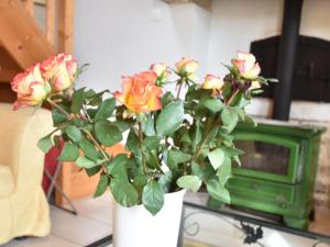 弗莱斯维尔布兰格力2号度假屋的电视旁边的桌子上摆放着玫瑰花的花瓶
