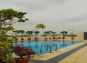特里凡得琅特里凡得琅帕迪科经典萨罗瓦尔酒店的一座在建筑中种满树木和鲜花的游泳池