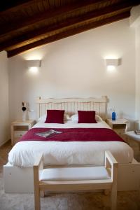 扎霍拉AROHAZ Hotel & Restaurante的卧室配有带红色枕头的大型白色床